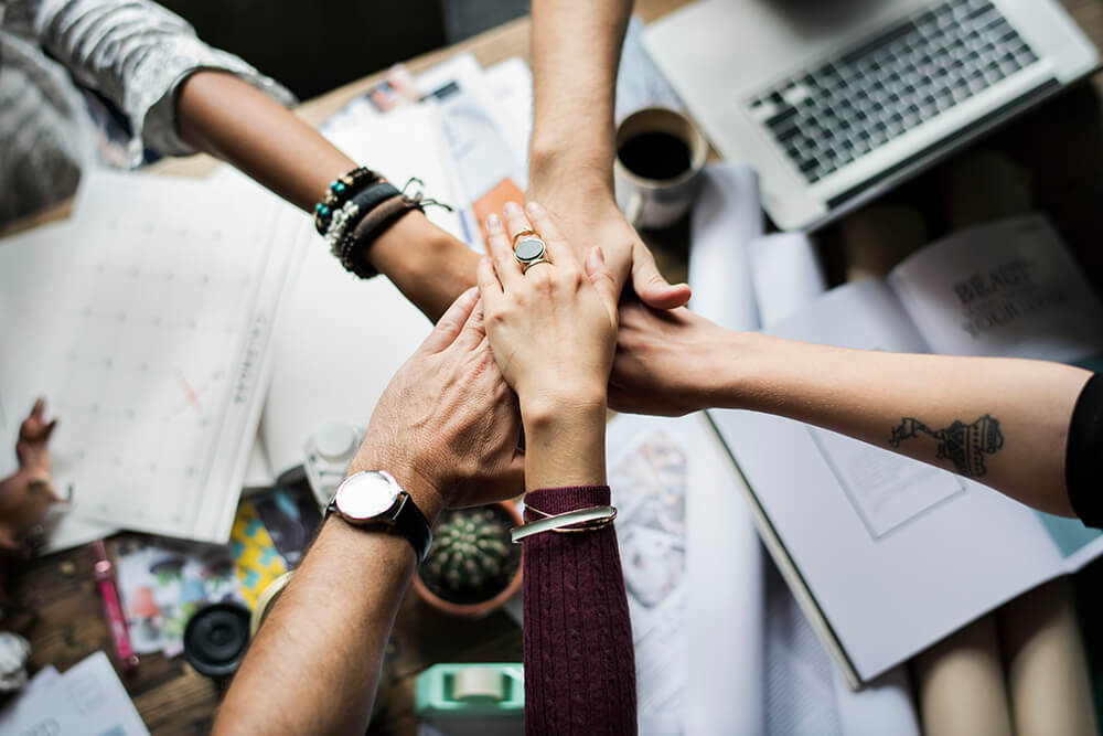 a group of people holding hands