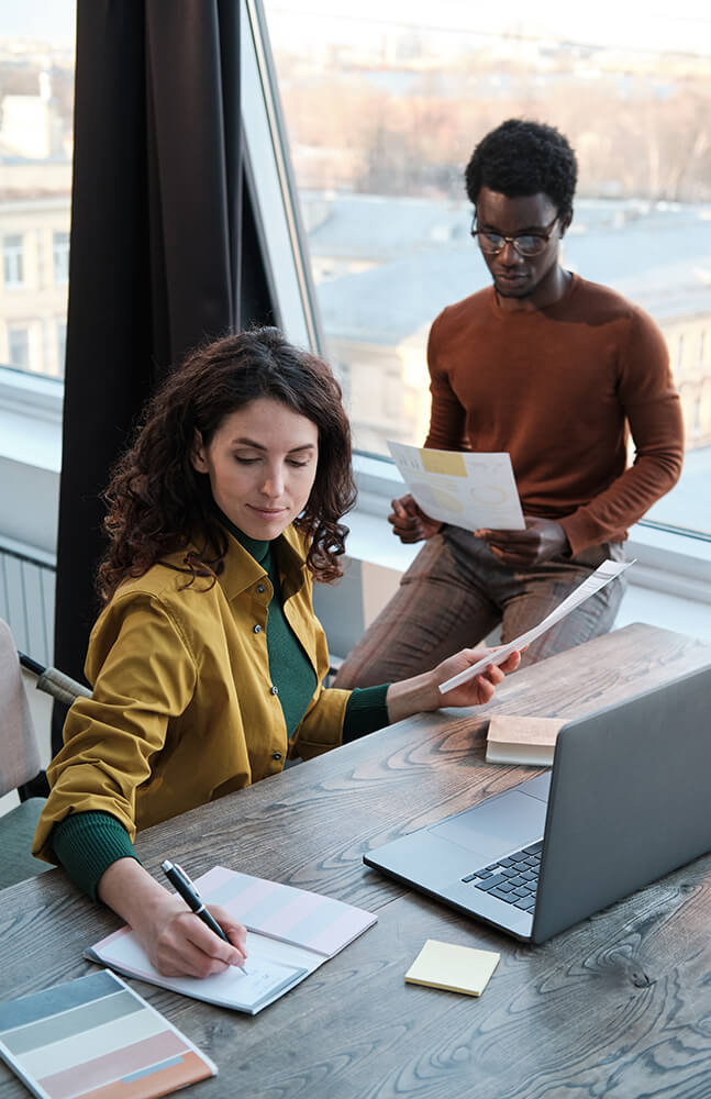 a man and a woman looking at a piece of paper