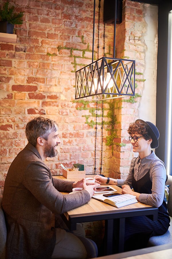 a couple of men sitting at a table