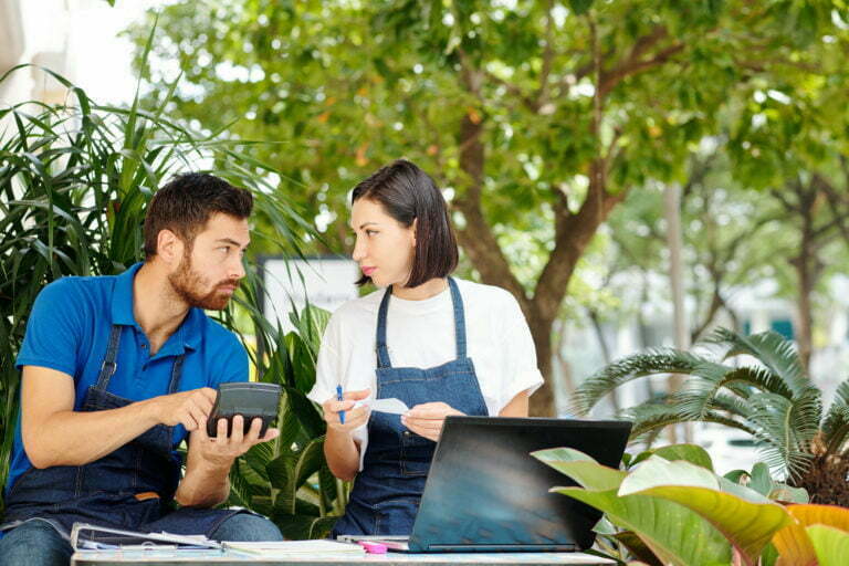 a man and a woman looking at a tablet